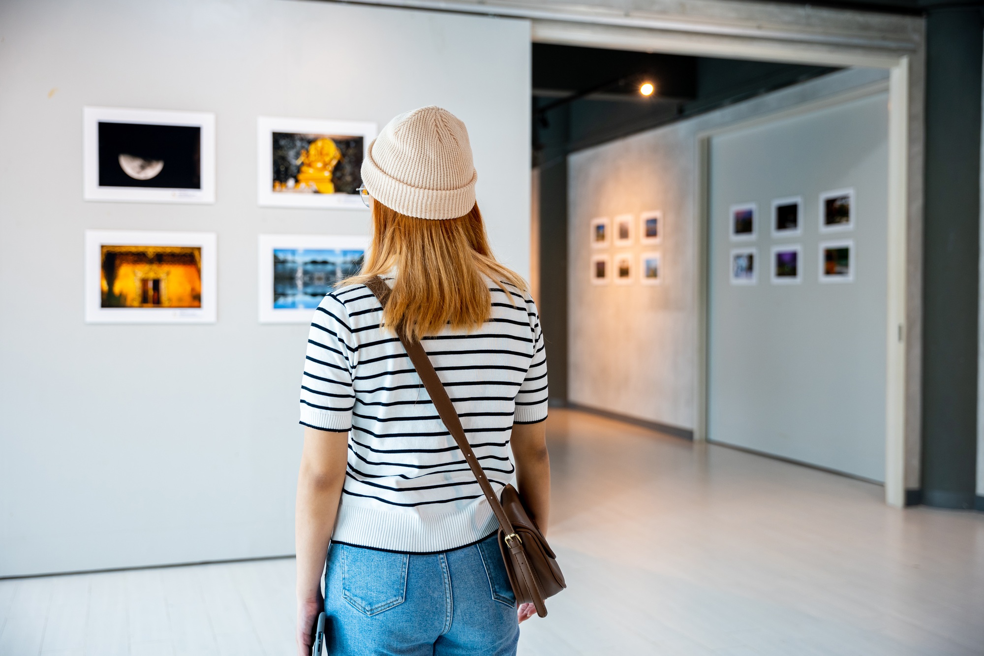 female watch at photo frame to leaning against at exhibit museum